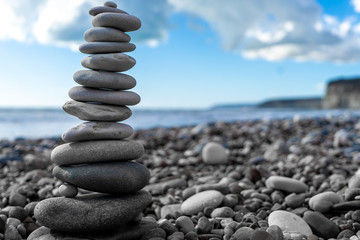 stone pyramid on the beach near the sea
