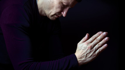 Man praying hands, hoping for best. Human emotion facial expression feeling. Prayer, people, church.