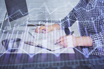 Double exposure of stock market chart with man working on computer on background. Concept of financial analysis.