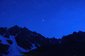 Starry night mountain landscape.