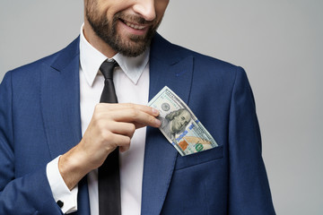 young handsome businessman holding US dollar bill