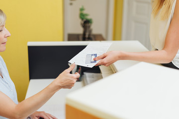 Patient handing over a completed registration form