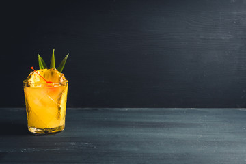 Old fahioned pineapple beverage on rustic background. Selective focus. Shallow depth of field.