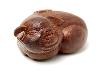 Laughing pig wood carving. pigs are chinese favorite animals on white background