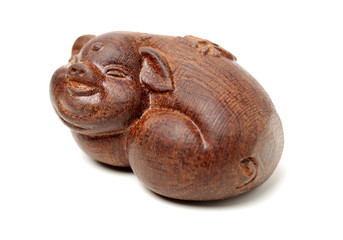 Laughing pig wood carving. pigs are chinese favorite animals on white background