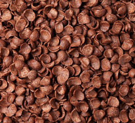 Chocolate cereal flakes background. Crispy chocolate crunch corn flakes. 