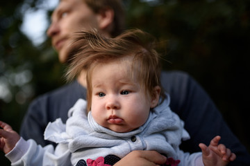 Young father having fun with his little daughter in park