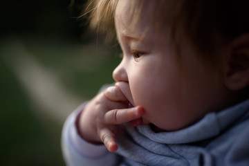 Close-up picture of baby touching cutting teeth