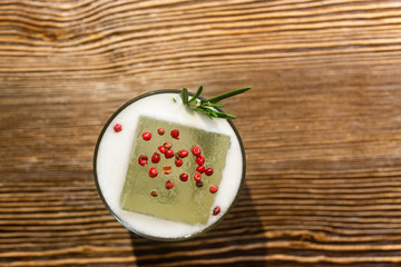 Top view of cocktail served on the wooden bar desk. 