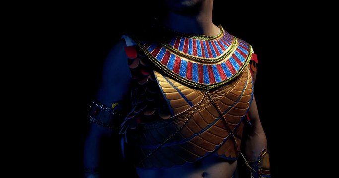 Close up of pharaoh in a dark room wearing traditional clothes and breathing, 4k