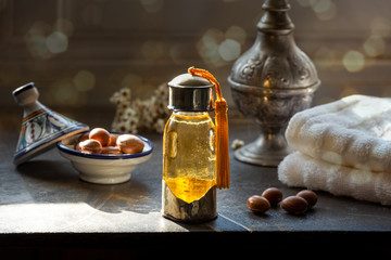 Bottle of Argan oil on a table with fruits - 317209595