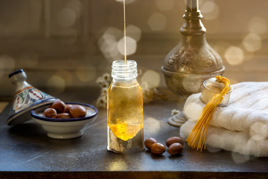 Bottle of Argan oil on a table with fruits