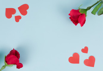 Red roses and red hearts on a blue background.