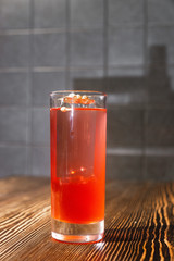 Pink and red Fresh colorful exotic alcoholic cocktail with lemon and ice in the bar. Colorful pink Soft drink with ice and decorated with dried flowers on the bar desk. Red colorful Mojito