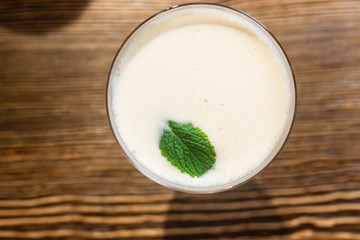 Top view of cocktail served on the wooden bar desk. 