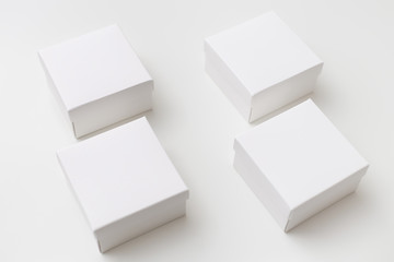 Mock up of four same size white boxes on the white background