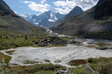 Fototapeta na wymiar Mountainous landscape. View at beautiful alpine valley with a river.
