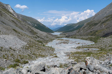 Mountainous landscape. View at beautiful alpine valley with a river. © Kirill