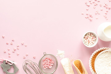 Frame of food ingredients for baking on a gently pink pastel background. Cooking flat lay with copy...