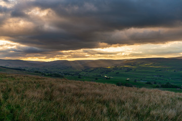 A cloudy sunset in the Yorkshire Dales near Countersett, North Yorkshire, England, UK