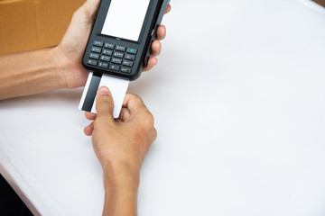 businessman hand using the card machine to pay the goods before packing in the box to deliver to the customer