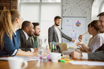 Brainmapping. Group of young business professionals having a meeting. Diverse group of coworkers discuss new decisions, plans, results, strategy. Creativity, workplace, business, finance, teamwork.