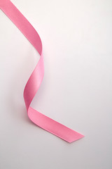 Pink curly ribbon isolated on white