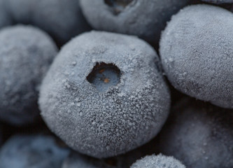 Frozen blueberries close up, blueberries background. Selective focus, shallow depth of field.