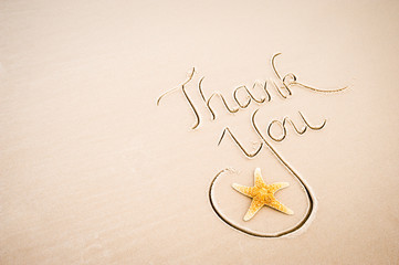 Thank You message handwritten in calligraphy with a starfish on a smooth stretch of beach with sand copy space