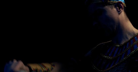 Close up of ancient egyptian pharaoh reading a scroll out loud, silhouette, 4k