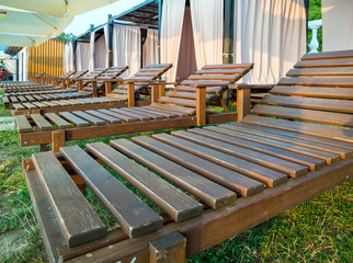 Wooden lounge chairs to stand in a row