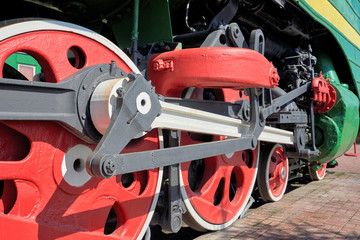Fragment of the chassis of the old engine, wheels, springs, axle boxes, pistons and cylinders