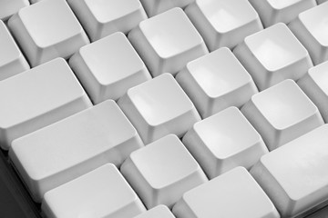 Close up shot of blank keys of white computer keyboard.