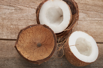 Coconut pieces pile on a wooden background