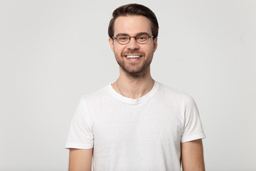 Fototapeta premium Happy smiling millennial guy wearing glasses head shot studio portrait.