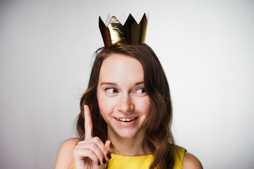 with a look of a conspirator, the girl raised her index finger up and slyly looks to the side, on...