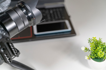 laptop camcorder blogger set on white table