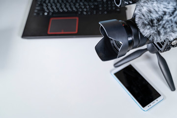 laptop camcorder blogger set on white table