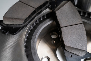 brake pads and auto parts on a white table