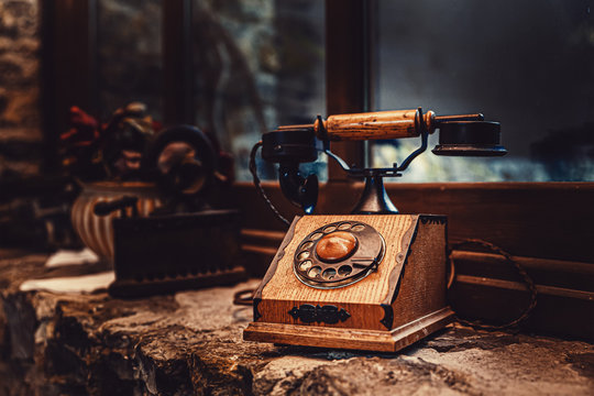 old brown wooden phone near the window.