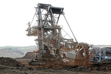 A huge bucket-wheel excavator digging coal on the open-pit mine.	