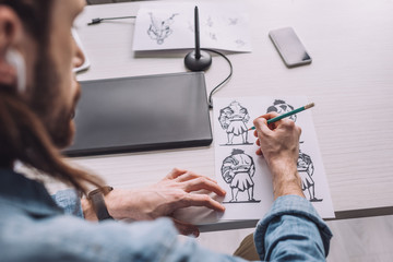 selective focus of illustrator drawing cartoon sketches