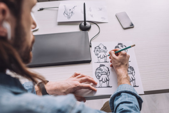 selective focus of illustrator drawing cartoon sketches