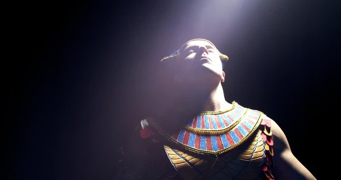 Egyptian pharaoh is lifting his head up and a beam of light strikes, 4k