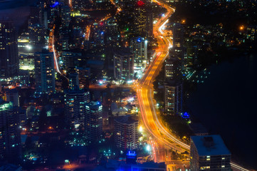 Aerial urban night traffic with busy street. Modern city infrastructure