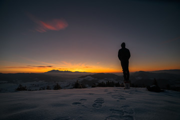 Fototapeta premium silhouette of man on top of mountain