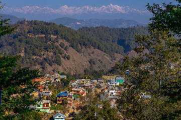 Nepali village in the hills. Great Himalaya Range in the backdrop