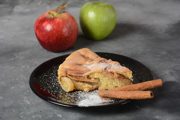Homemade apple pie with sugar powder and cinnamon. Traditional American or English dessert 