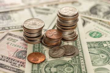 Stacks of coins on dollar bills