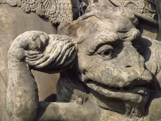 Fototapeta na wymiar Devil face, detail of sculpture Saint Procopius of Sazava, Bohemian canon and hermit, baroque statue in the open countryside, religious sculpture, Czech republic